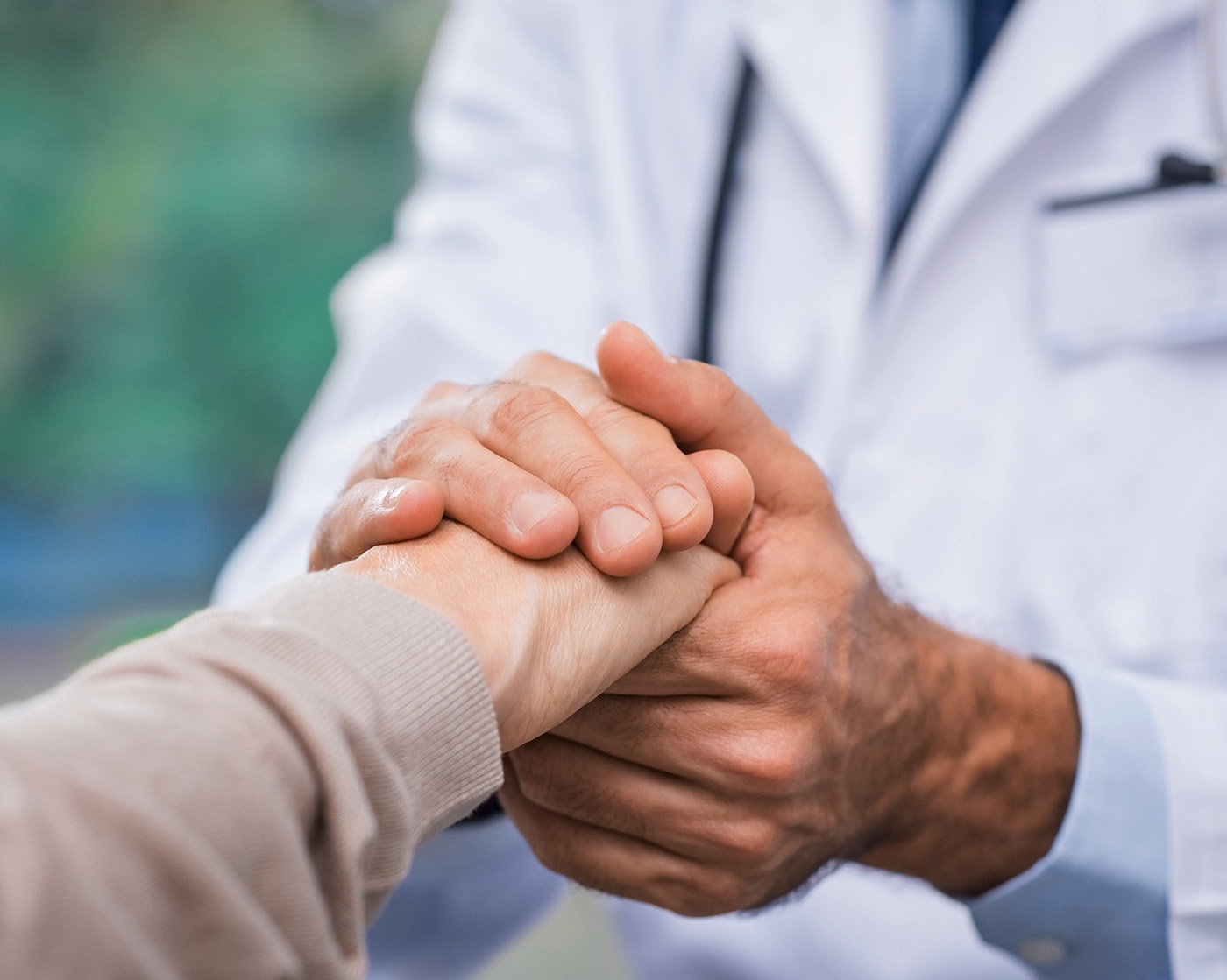 doctor holding a patients hand