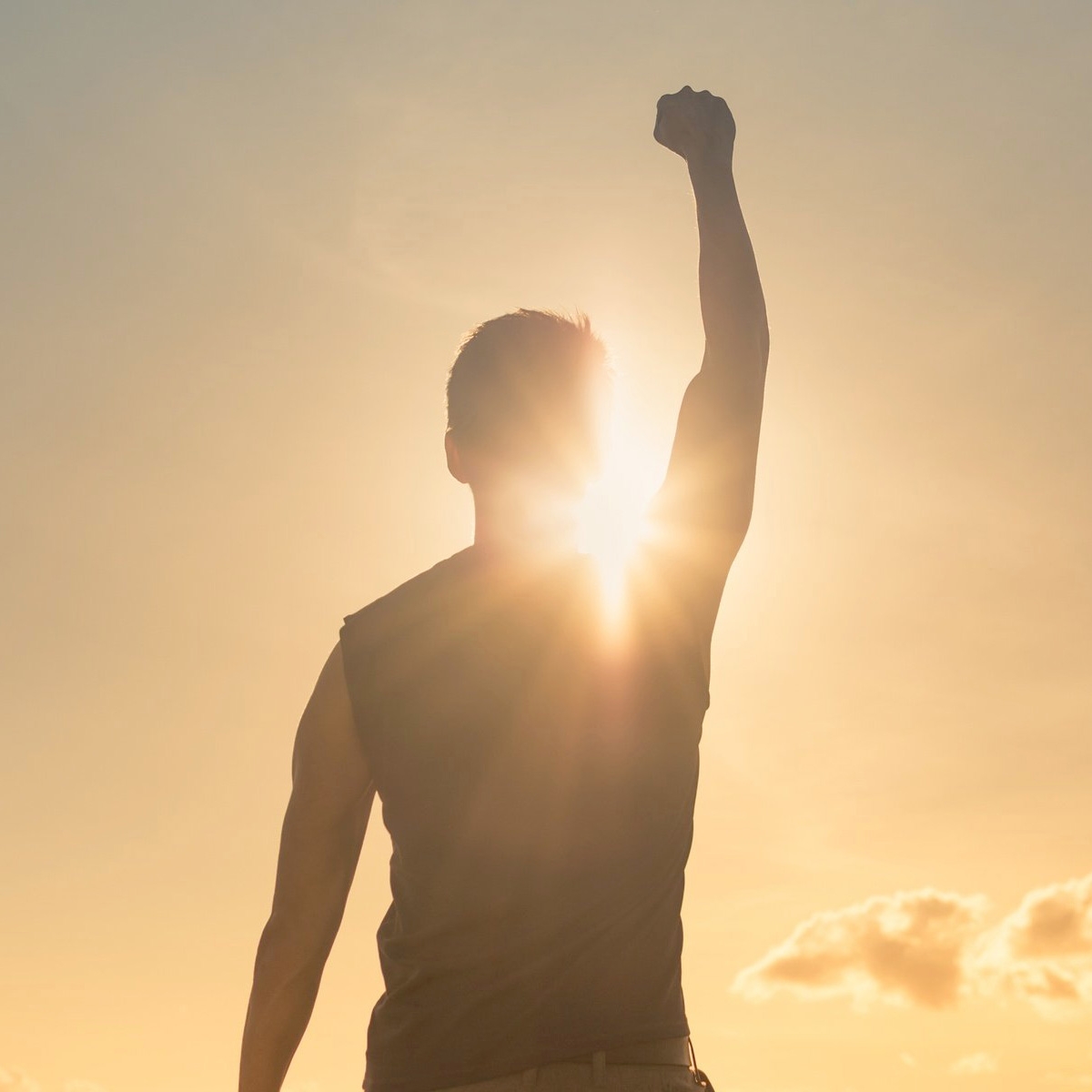 man raising his fist to the sky